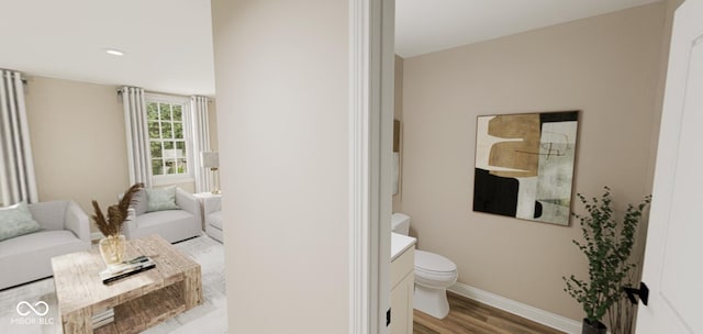 bathroom with wood-type flooring, toilet, and vanity