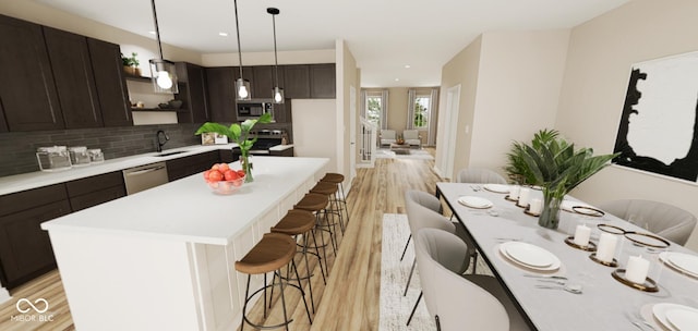 kitchen featuring a center island, decorative backsplash, sink, pendant lighting, and light wood-type flooring