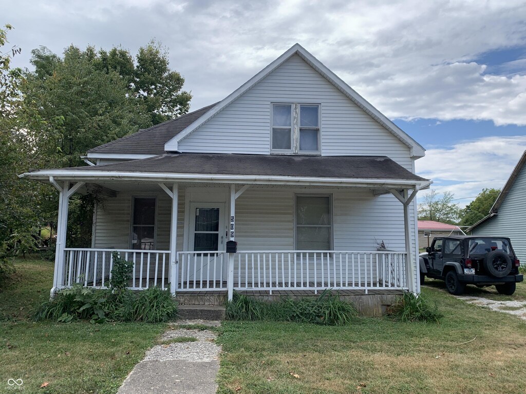 bungalow-style house featuring a front yard and a porch