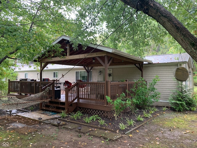 back of house with a wooden deck