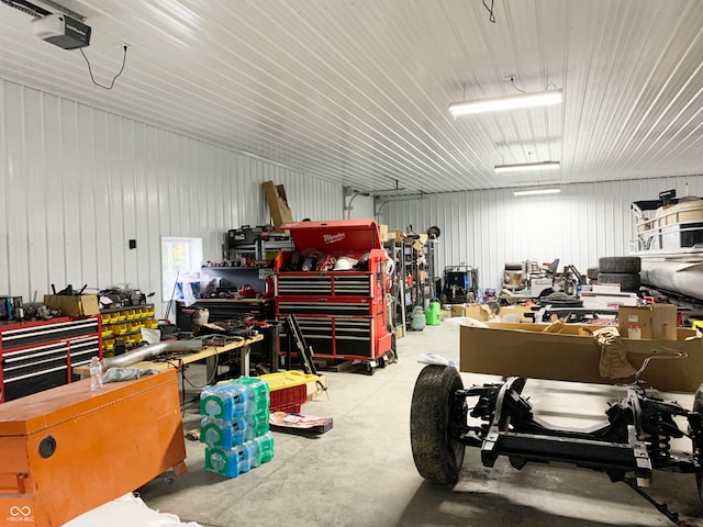 garage with a garage door opener and a workshop area