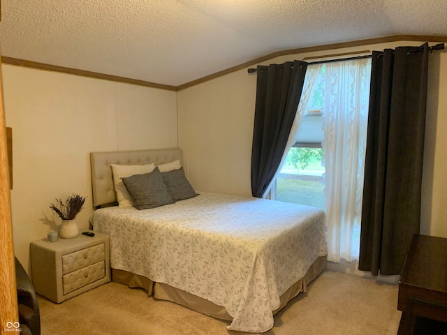 carpeted bedroom featuring a textured ceiling and lofted ceiling