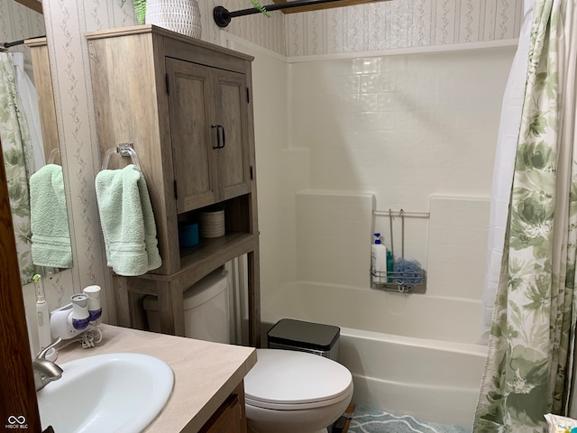 full bathroom with vanity, shower / tub combo, and toilet