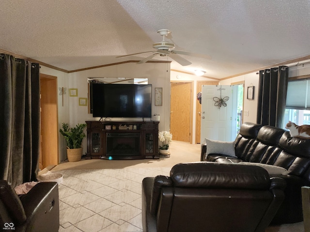 living room with a textured ceiling, ornamental molding, ceiling fan, and light colored carpet