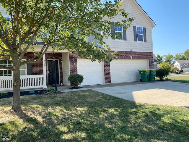 view of front facade featuring a garage and a front lawn