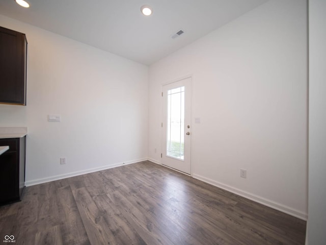 unfurnished living room featuring dark wood-type flooring