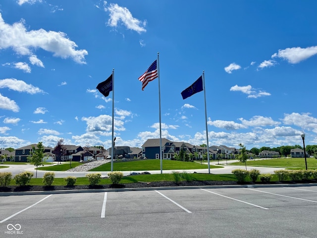 view of vehicle parking with a lawn