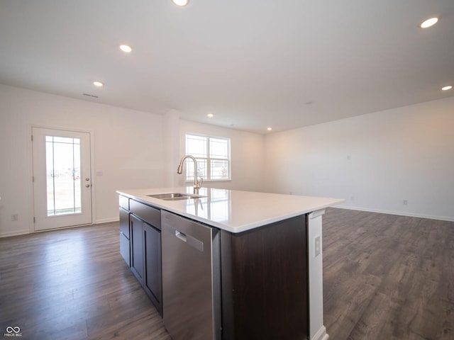 kitchen with a center island with sink, sink, stainless steel dishwasher, and dark wood-type flooring