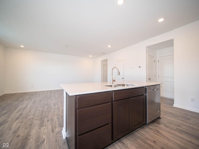 kitchen with sink, dishwasher, hardwood / wood-style floors, dark brown cabinets, and a center island with sink