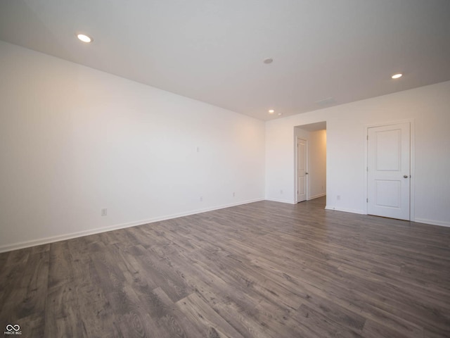 unfurnished room with dark hardwood / wood-style floors