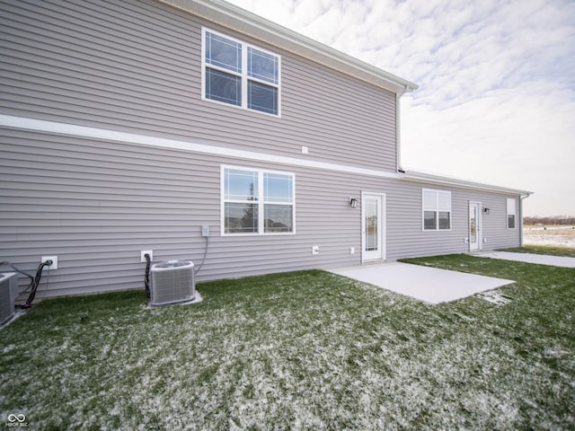 back of property with a patio, a yard, and central AC unit