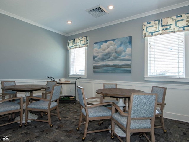 carpeted dining area with crown molding