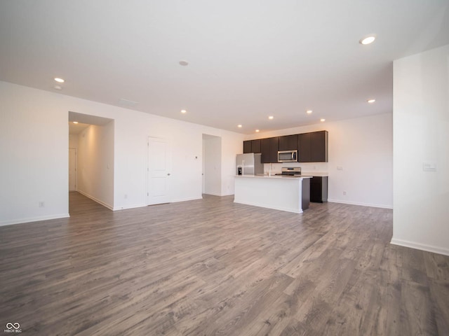 unfurnished living room with dark hardwood / wood-style flooring