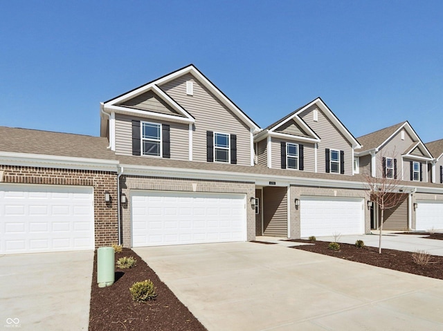 view of front of home featuring brick siding, concrete driveway, and an attached garage