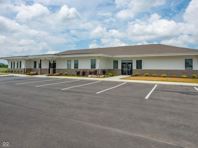 view of building exterior featuring uncovered parking