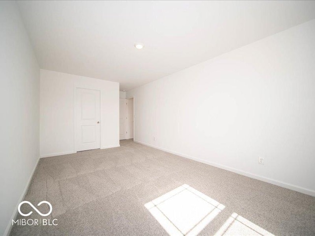 unfurnished bedroom featuring carpet and baseboards