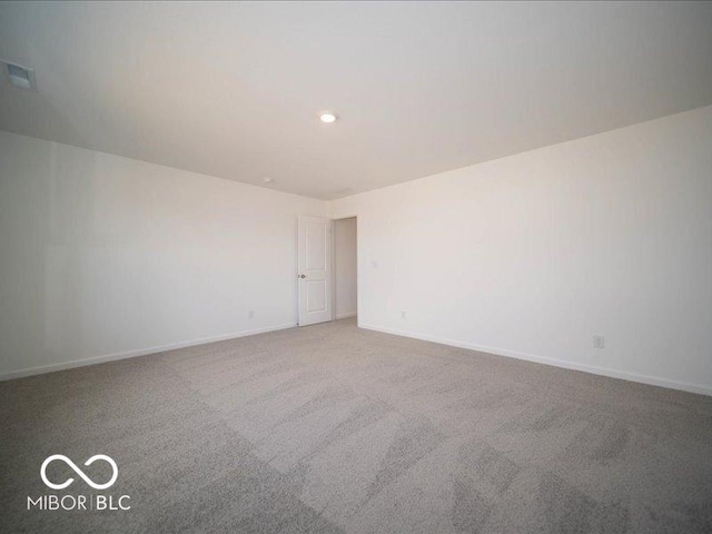 carpeted empty room with visible vents and baseboards