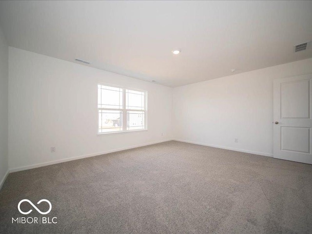 carpeted spare room with recessed lighting, visible vents, and baseboards