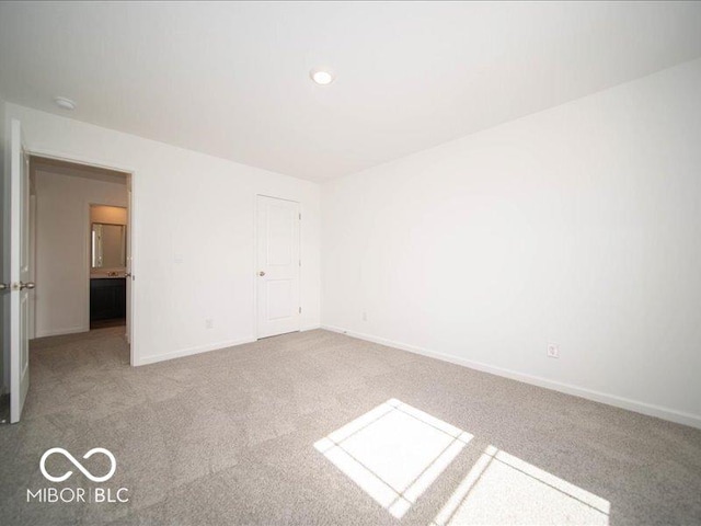 unfurnished bedroom featuring baseboards and carpet flooring