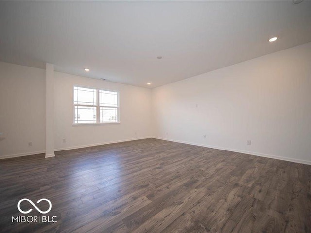 unfurnished room with dark wood-style floors, recessed lighting, and baseboards