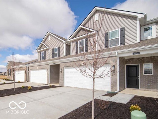 view of front of house featuring brick siding, driveway, and an attached garage