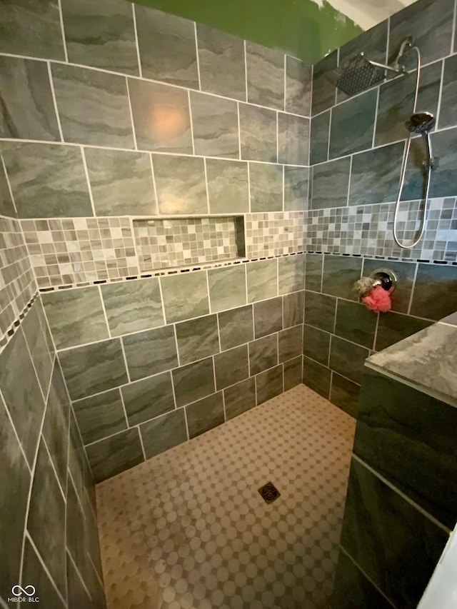 bathroom with tiled shower