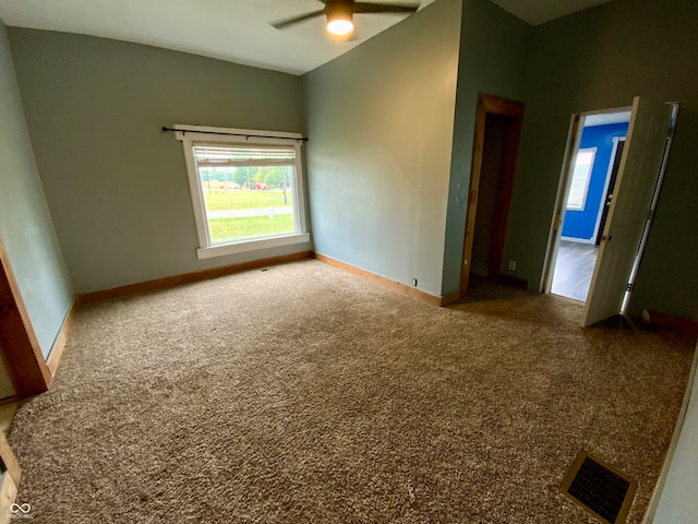 carpeted spare room with ceiling fan