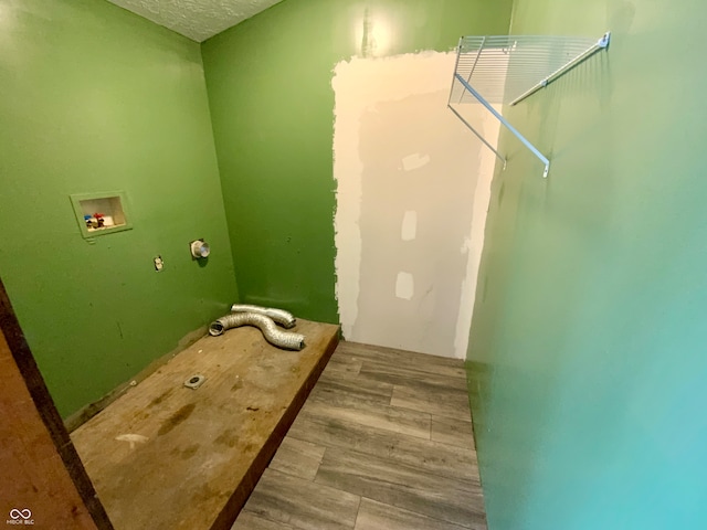 laundry room featuring washer hookup and hardwood / wood-style flooring