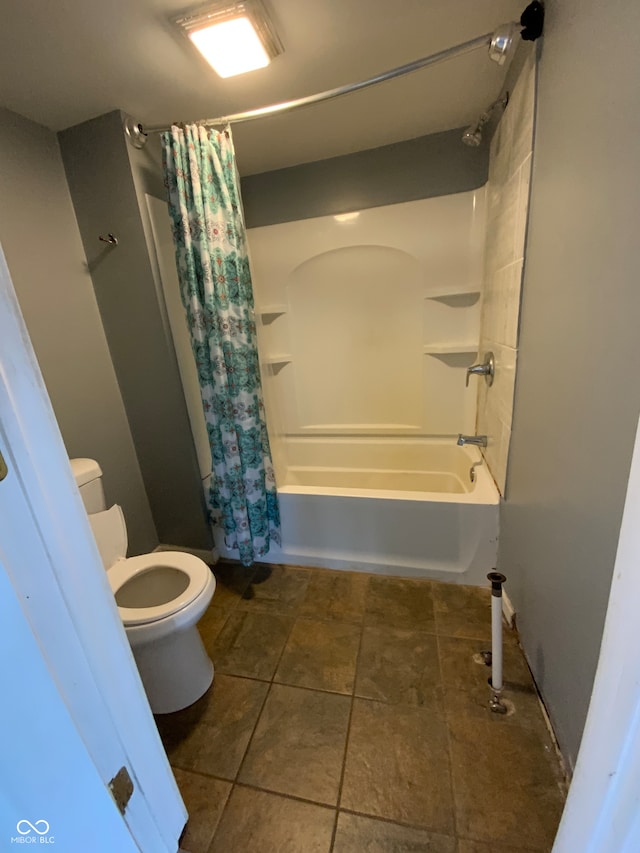 bathroom with shower / bath combo and toilet