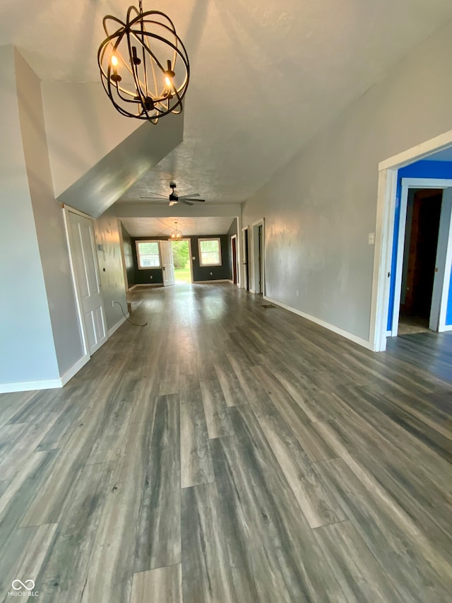 unfurnished living room featuring ceiling fan with notable chandelier and hardwood / wood-style flooring