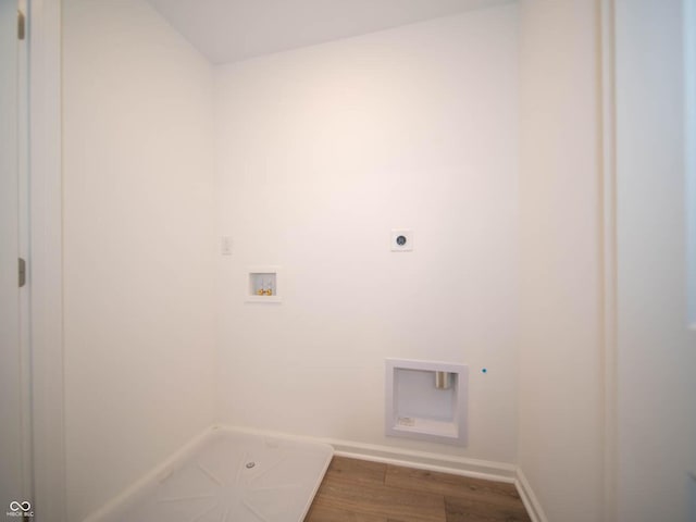 clothes washing area featuring wood-type flooring, hookup for an electric dryer, and washer hookup