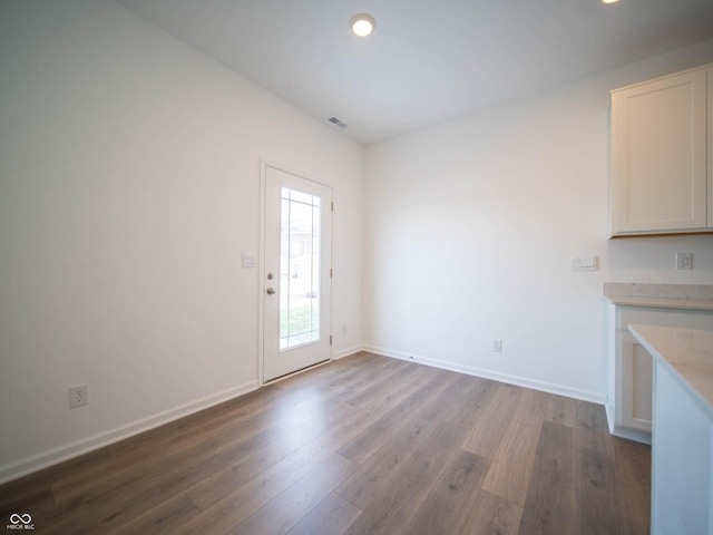 unfurnished dining area with wood-type flooring