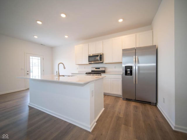 kitchen with sink, an island with sink, white cabinetry, and appliances with stainless steel finishes