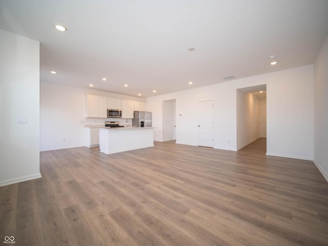 unfurnished living room with light wood-type flooring