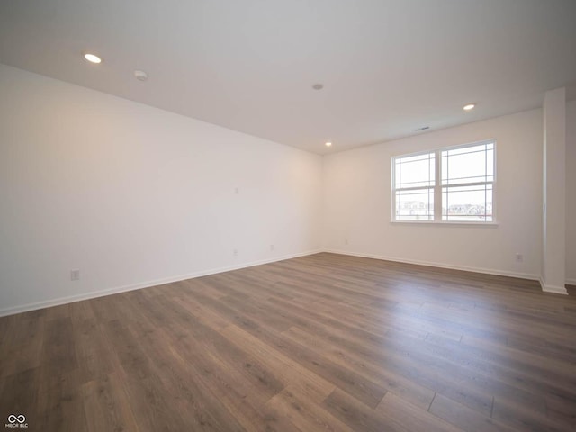 unfurnished room featuring dark hardwood / wood-style flooring