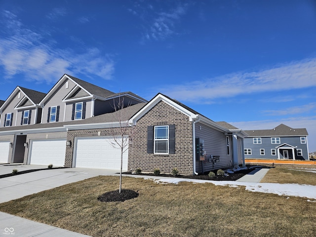 view of front of house with driveway, brick siding, and a front yard