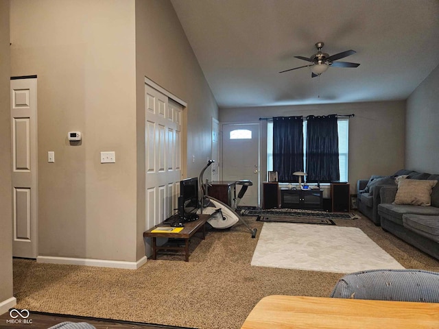 living room with carpet floors, ceiling fan, and baseboards
