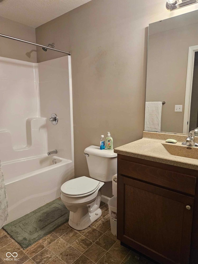 bathroom with vanity, washtub / shower combination, and toilet