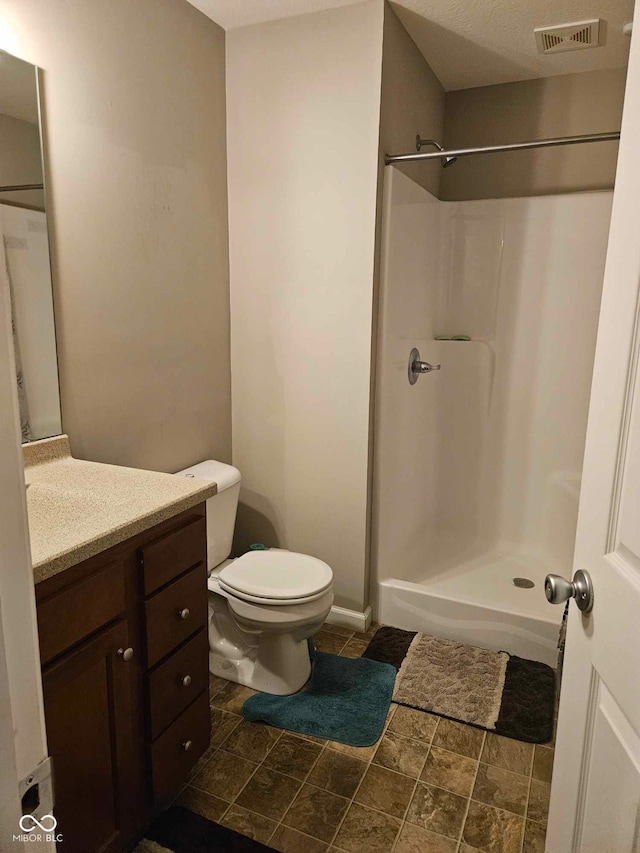 full bath with vanity, toilet, a shower, and visible vents