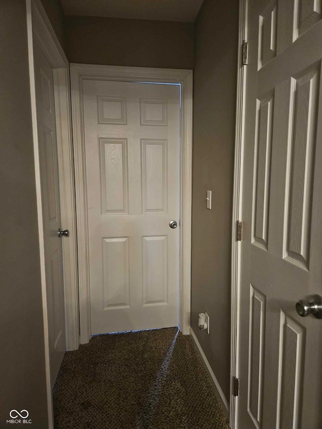 hall with carpet floors and baseboards