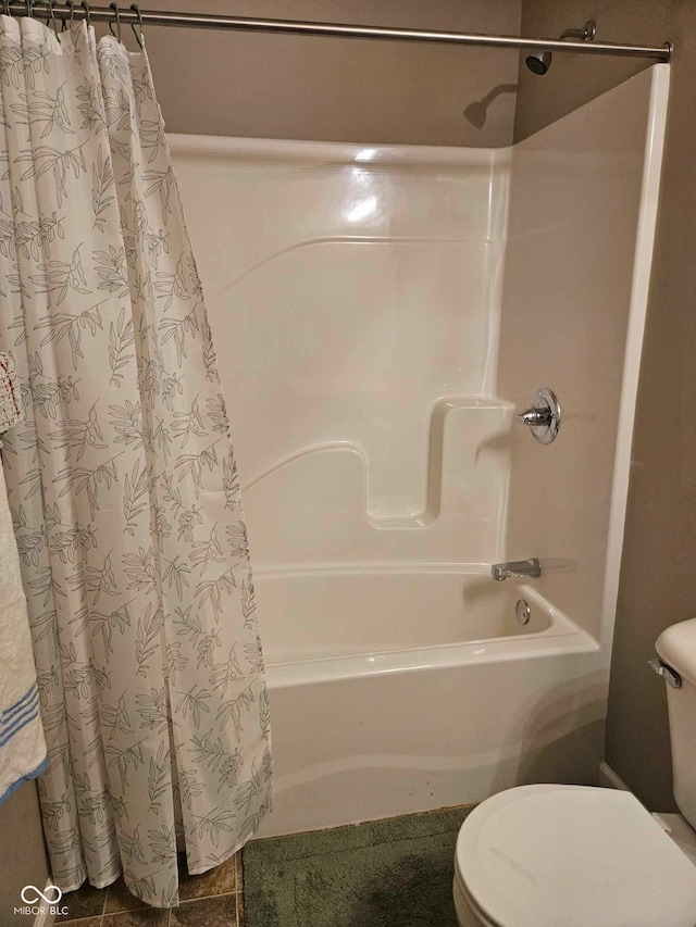 full bathroom featuring toilet and shower / bath combination with curtain