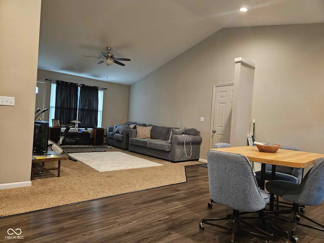 living area with baseboards, ceiling fan, dark wood-style flooring, and lofted ceiling