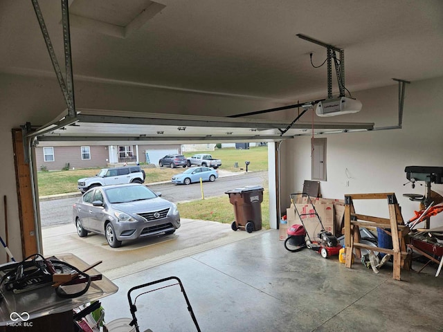 garage featuring a garage door opener and electric panel