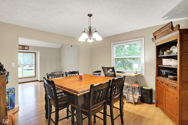 2747 E Midland Rd, Indianapolis, IN 46227 - dining room featuring a chandelier, light wood finished floors, plenty of natural light, and a textured ceiling