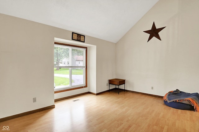 2747 E Midland Rd, Indianapolis, IN 46227 - empty room with wood finished floors, lofted ceiling, and baseboards