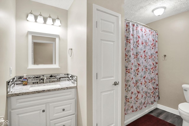 2747 E Midland Rd, Indianapolis, IN 46227 - bathroom featuring toilet, a textured ceiling, vanity, wood finished floors, and baseboards