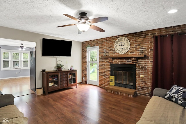 2747 E Midland Rd, Indianapolis, IN 46227 - living room with a ceiling fan, wood finished floors, a textured ceiling, plenty of natural light, and brick wall