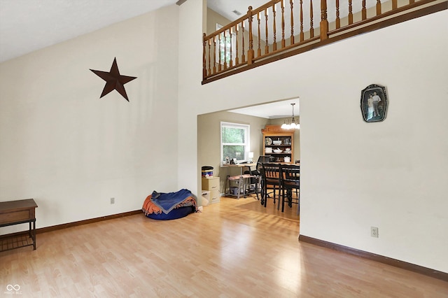2747 E Midland Rd, Indianapolis, IN 46227 - living area with wood finished floors, a high ceiling, baseboards, and a chandelier
