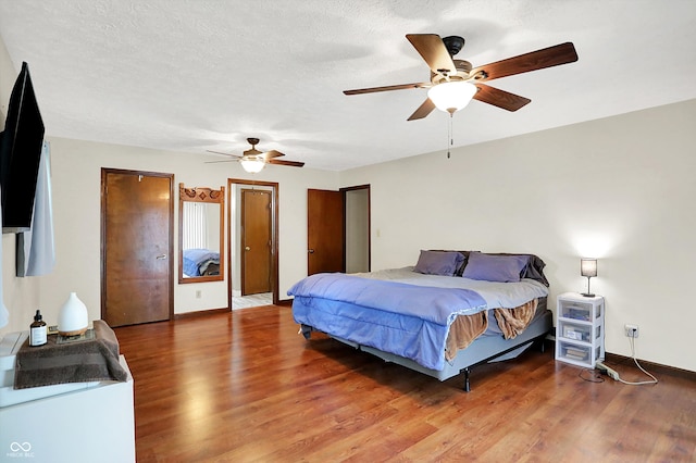 2747 E Midland Rd, Indianapolis, IN 46227 - bedroom featuring wood finished floors, a ceiling fan, multiple closets, and baseboards