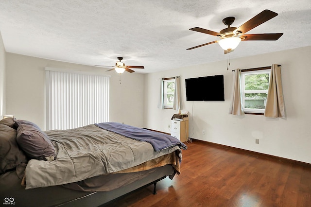 2747 E Midland Rd, Indianapolis, IN 46227 - bedroom with multiple windows, dark wood-style floors, baseboards, a textured ceiling, and a ceiling fan